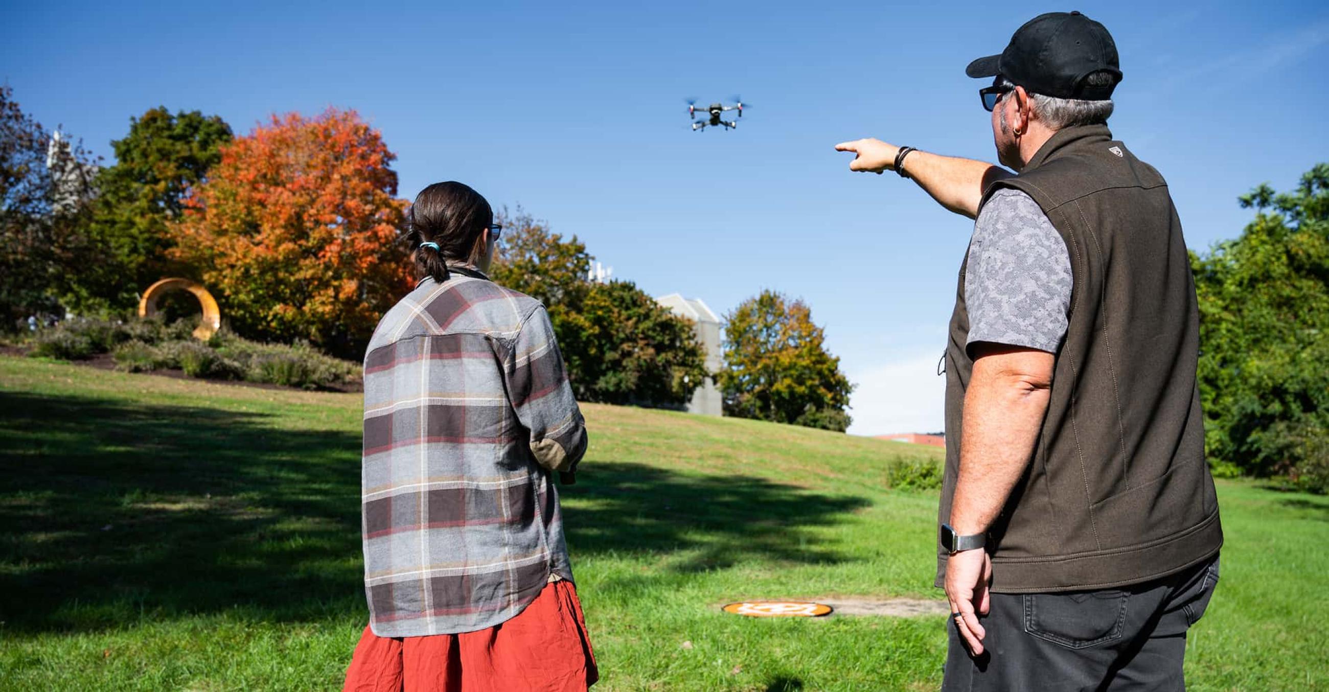 an instructor works with a student on using a drone