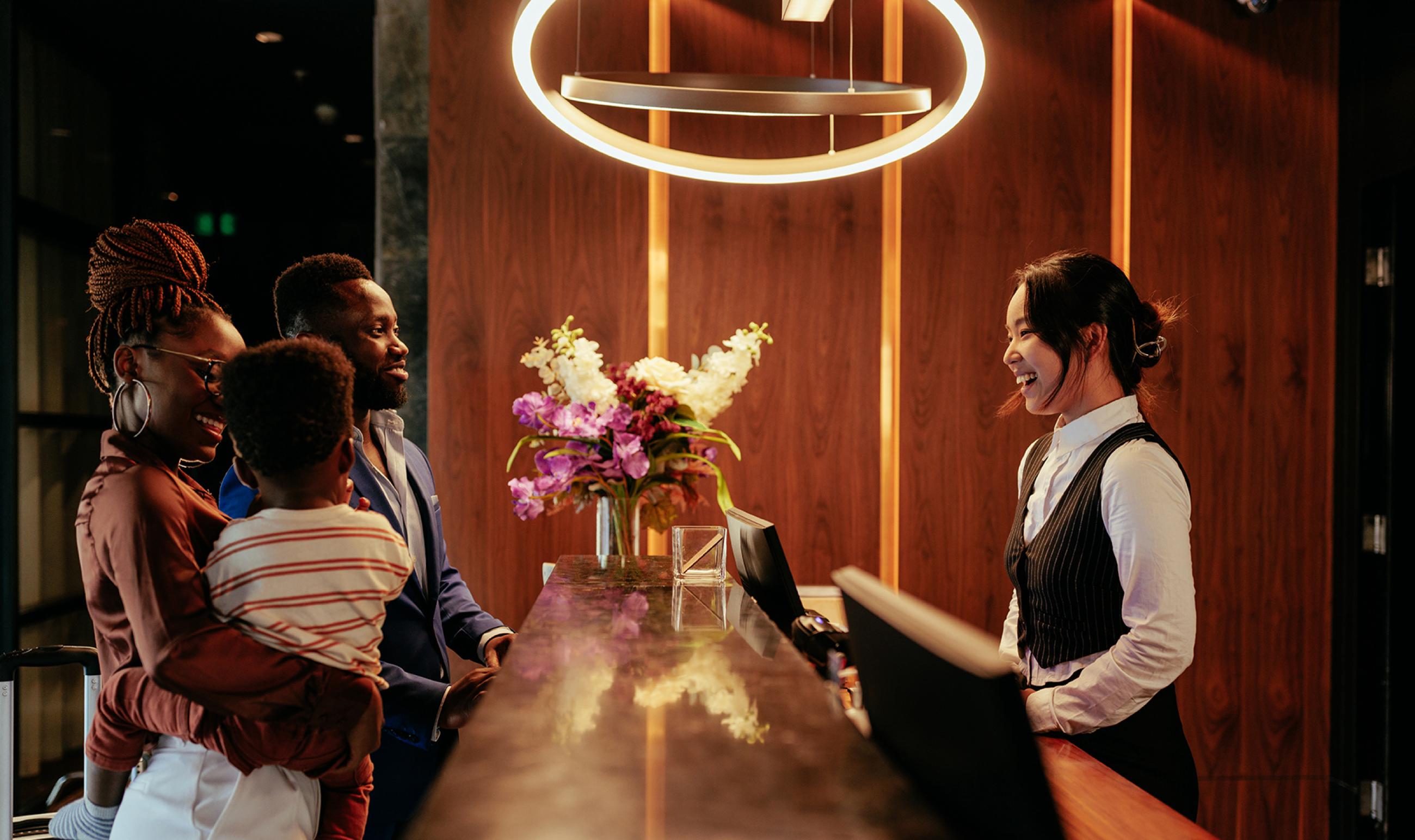 A family at the front desk checking into a hotel