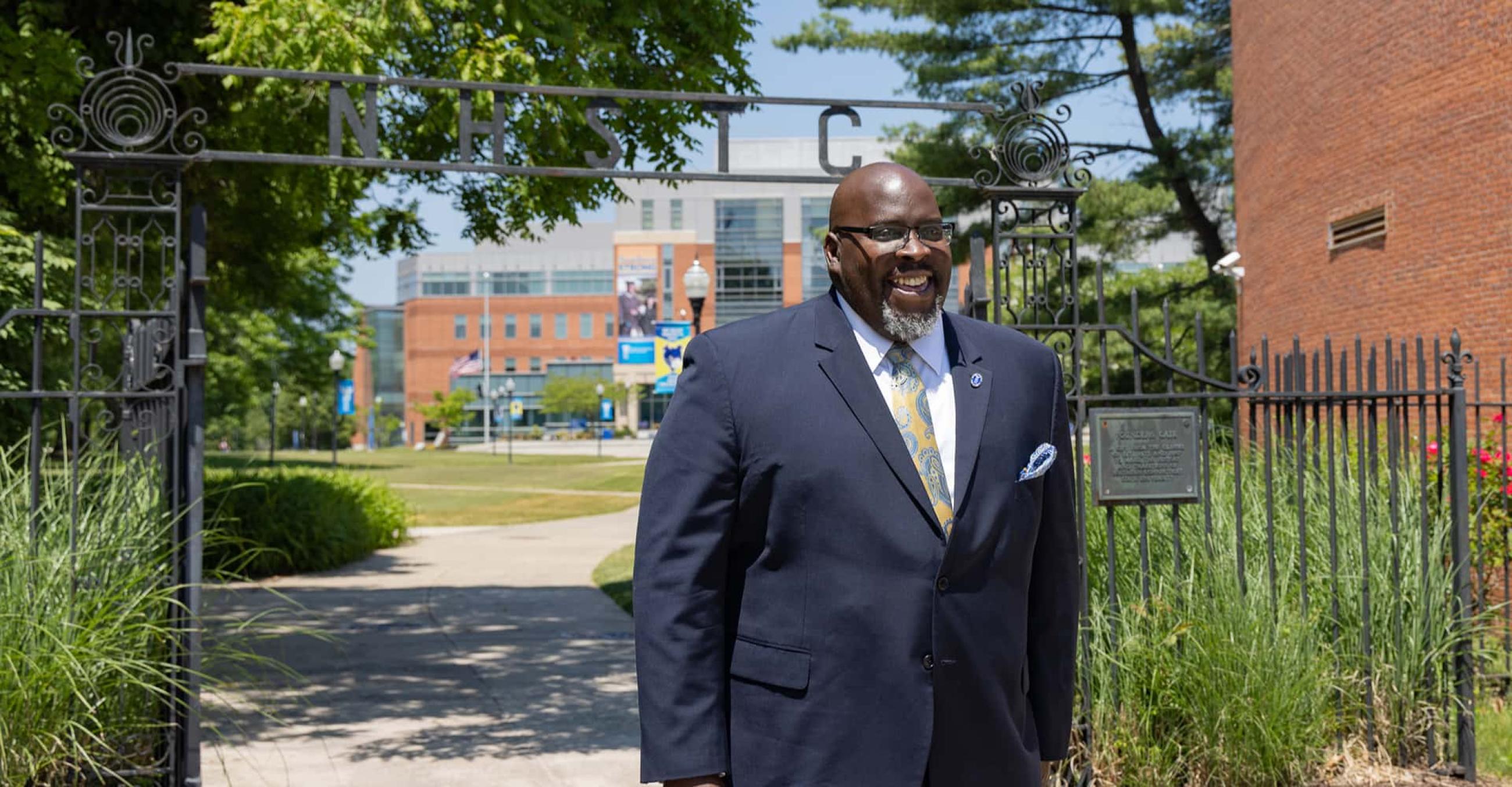 Dr. Dwayne Smith walks through Founders Gate on the SCSU campus