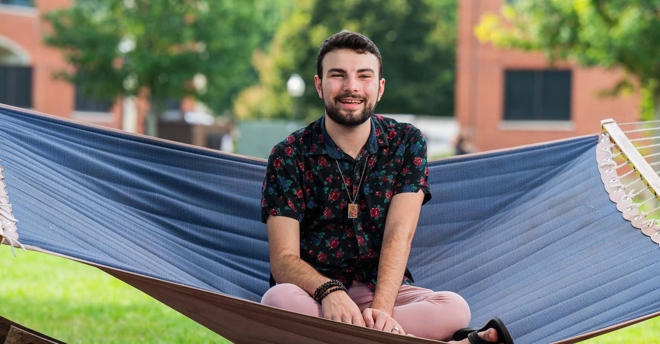Kyle Magri sits in a hammock on the Southern campus