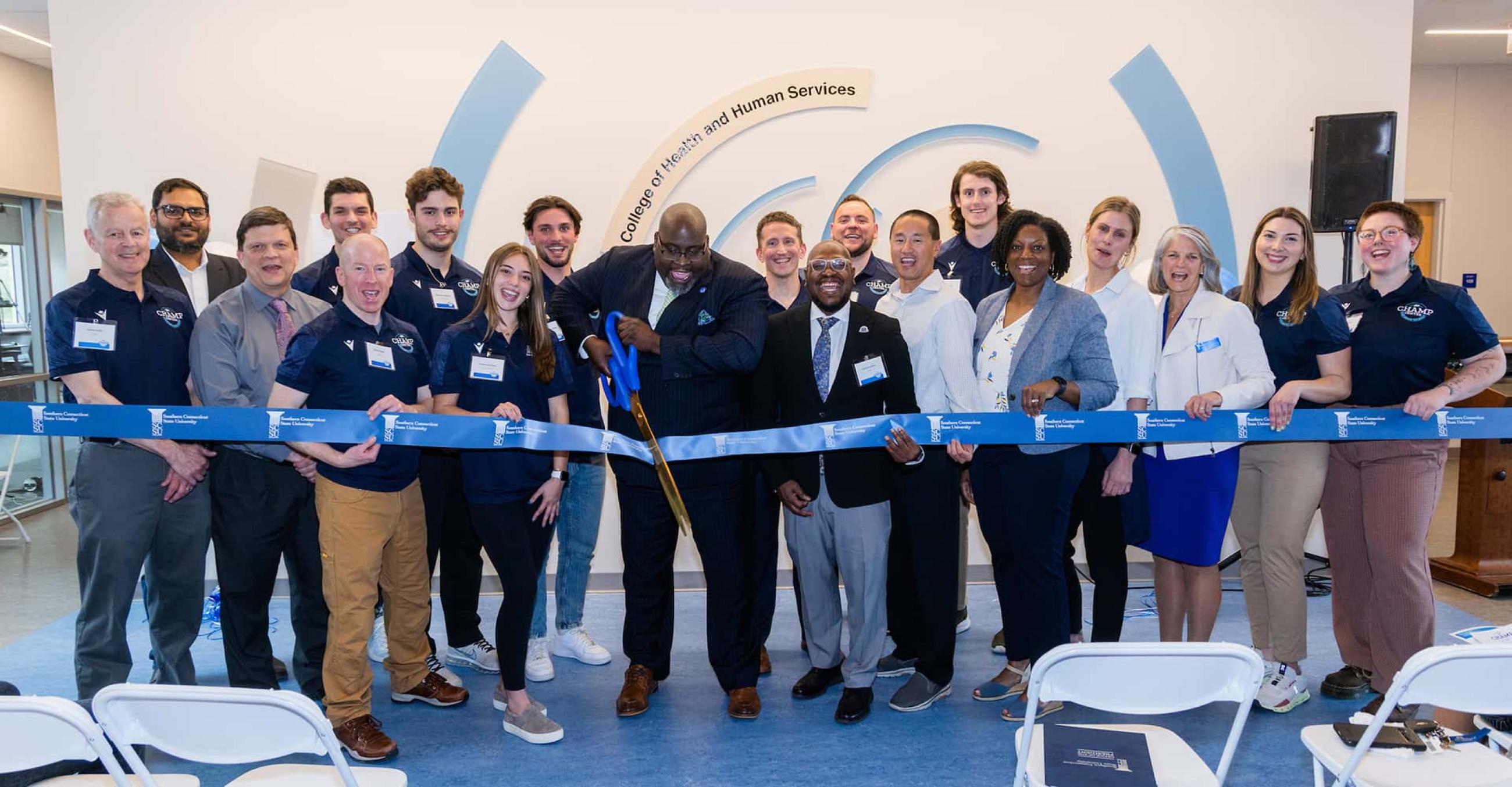 the ceremonial ribbon-cutting to open CHAMP, featuring faculty, staff, and students of the College of Health and Human Services and Interim President Dwayne Smith