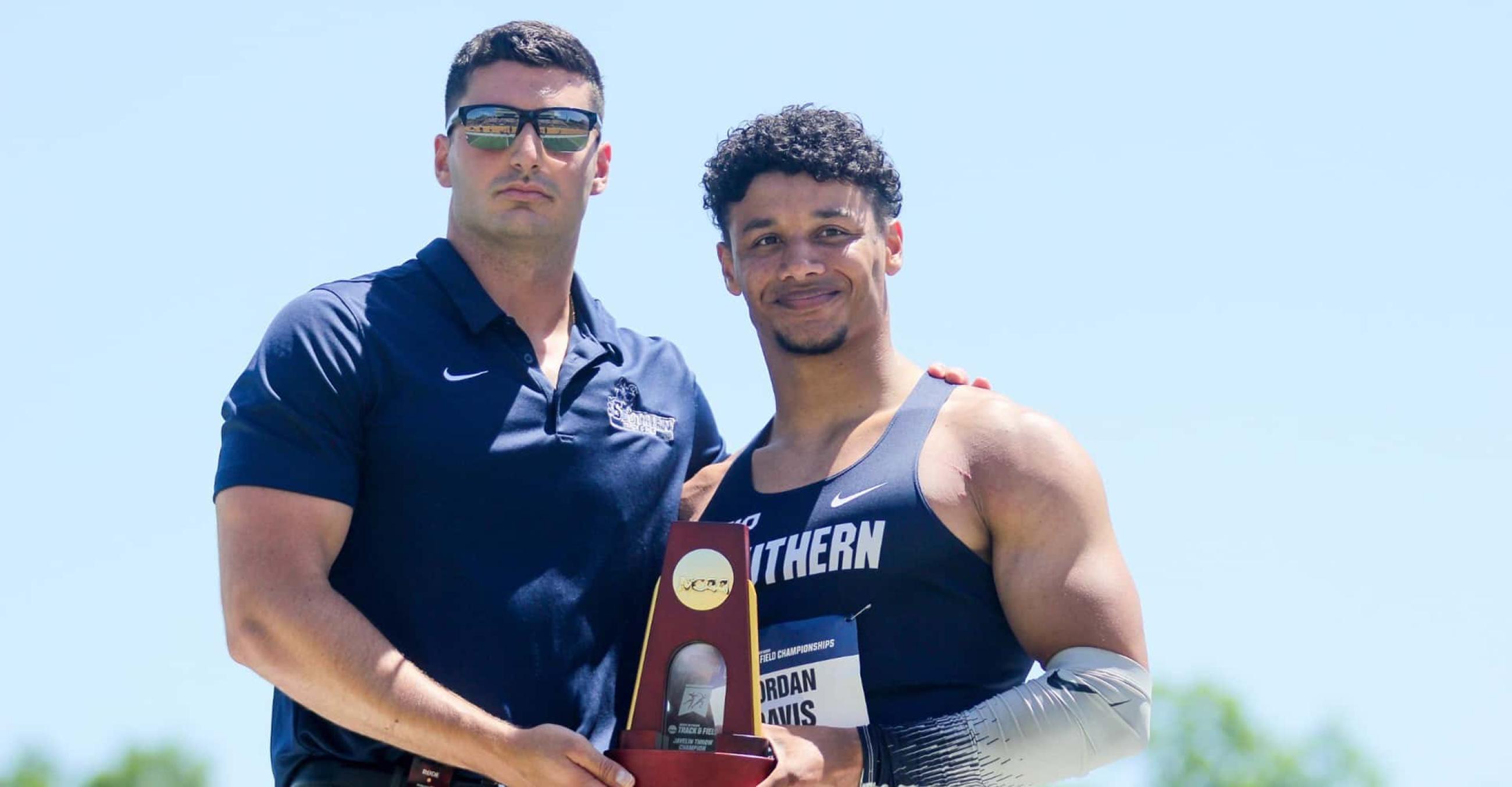  Jordan Davis, '24 (right), with Dan Labbadia, assistant men's track & field coach, after Davis won the NCAA Division II National Championship in the javelin throw