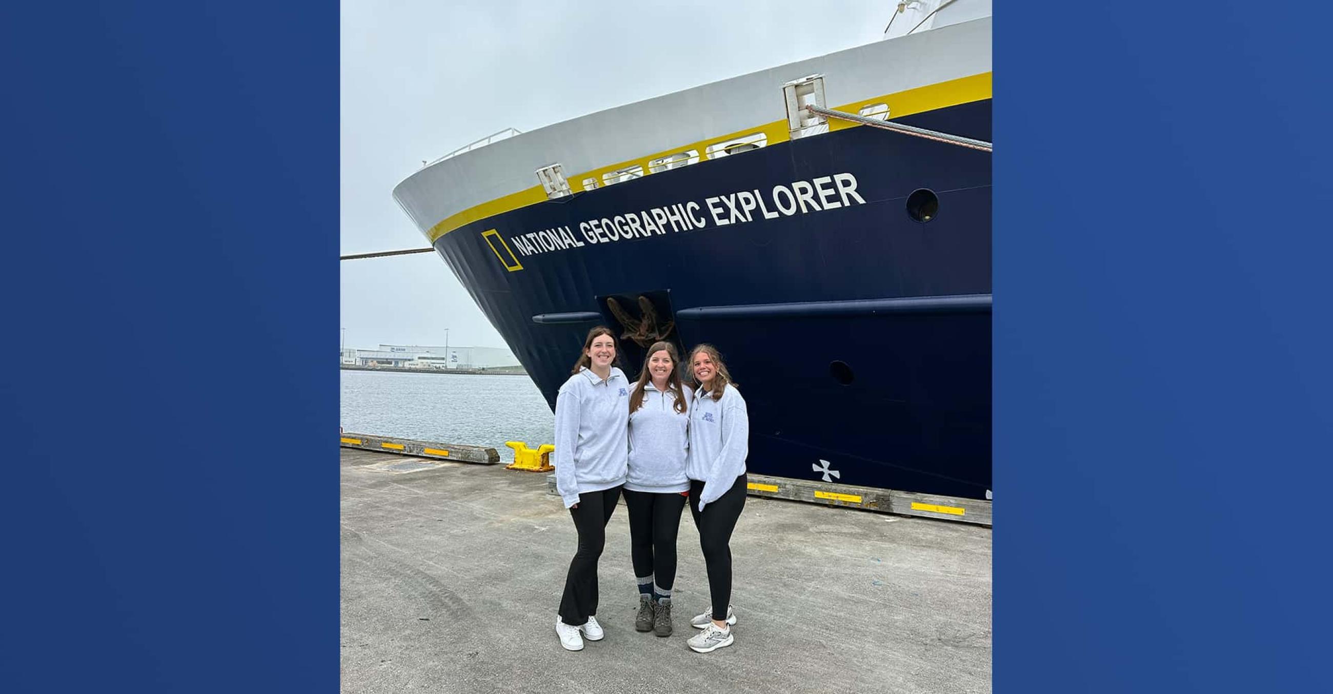 Graduate students Katie Wagner and Olivia Vallejo with EGMS Professor Emma Cross stand near the Lindblad Expedition National Geographic ship in Iceland