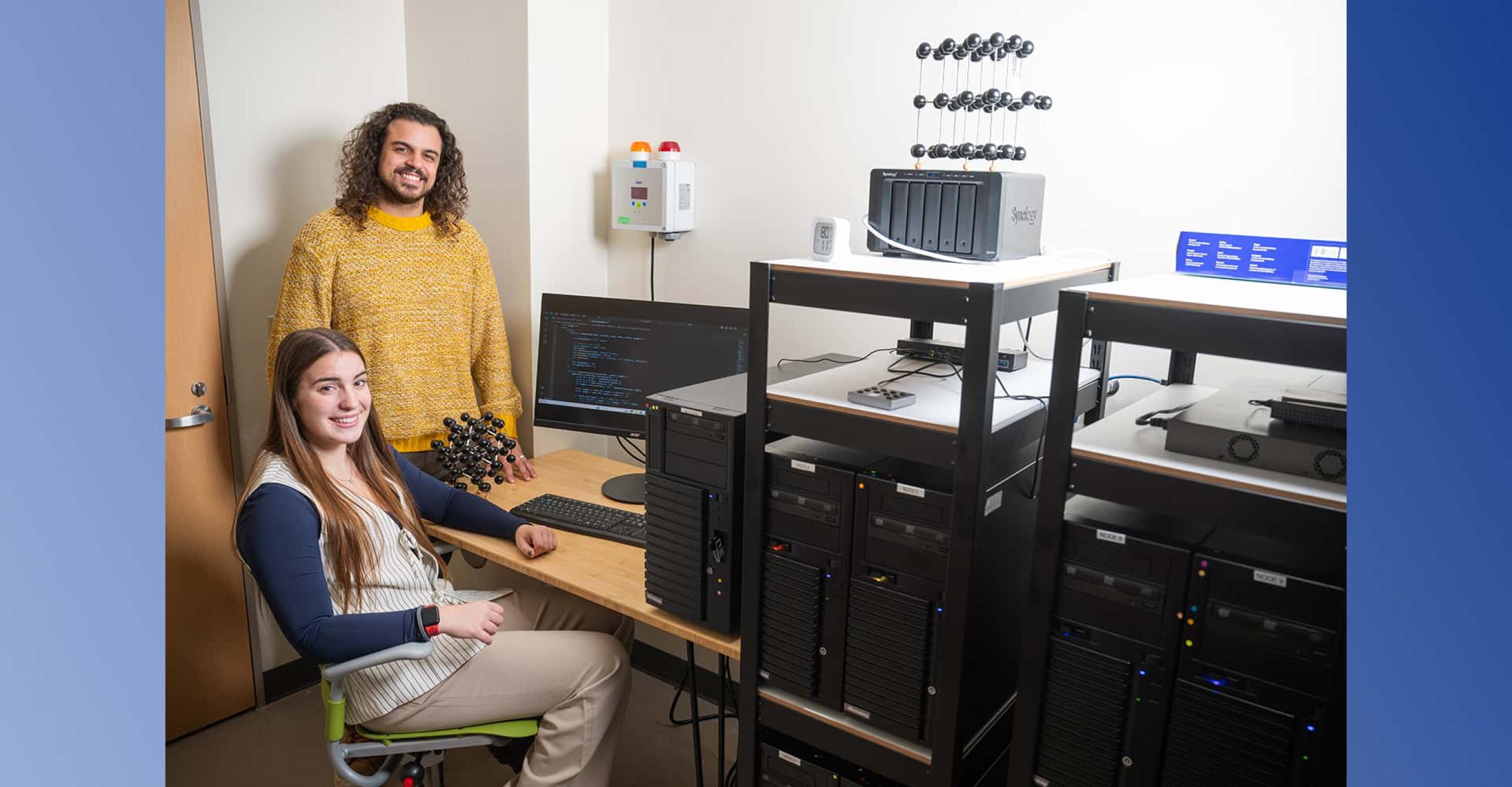 Physics majors Maggie Blanchard and Andre Correa working at the high-performance computing cluster in the QNT