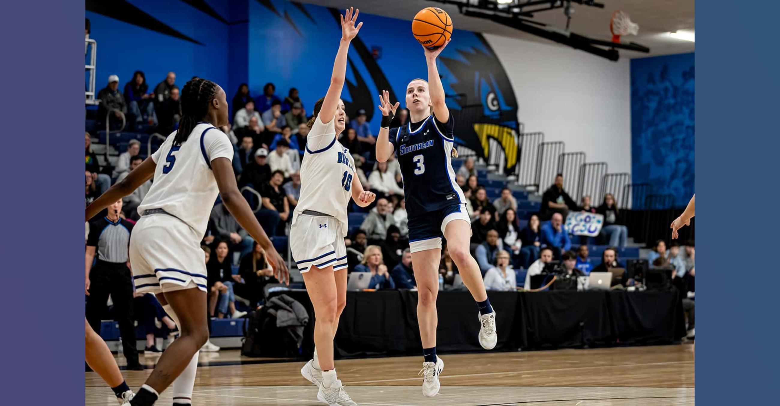 three basketball players engaged in playing a game