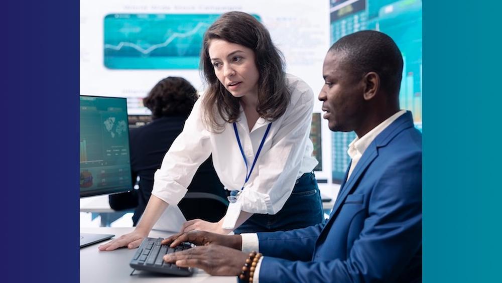 Two business people working on a computer