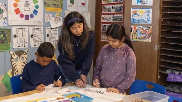 Teacher and two students in a classroom