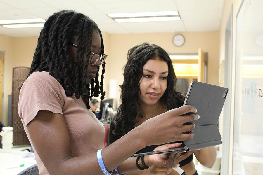 Two PASS students working together on a touchscreen device
