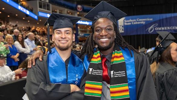 Two graduates at commencement