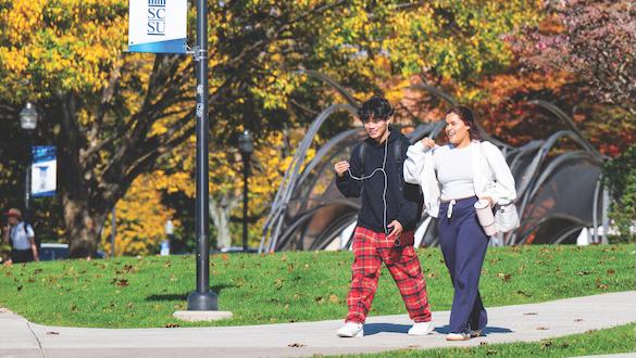 Two students walking through Southerns campus in the fall