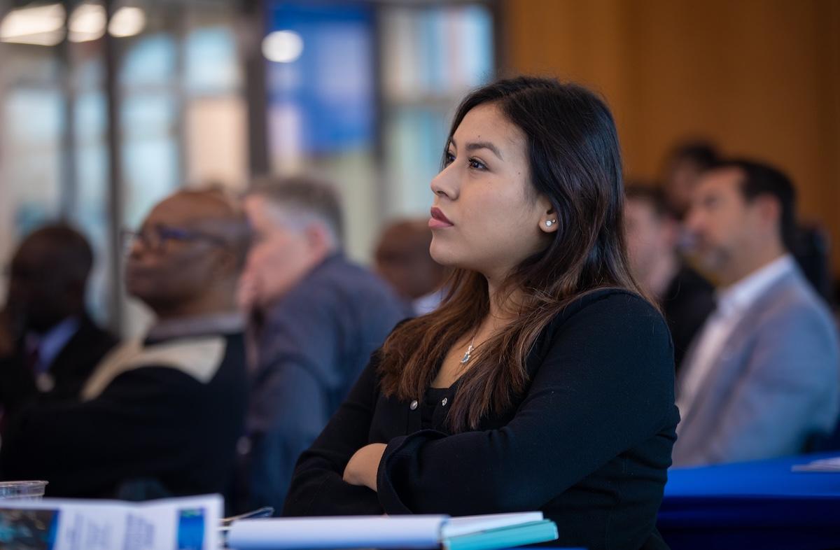 Woman and audience listening to a business speaker