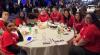 "A group of students in the Jumpstart program sitting at a round table at an event