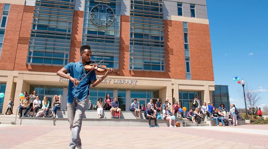 Violinist playing in front of Buley Library